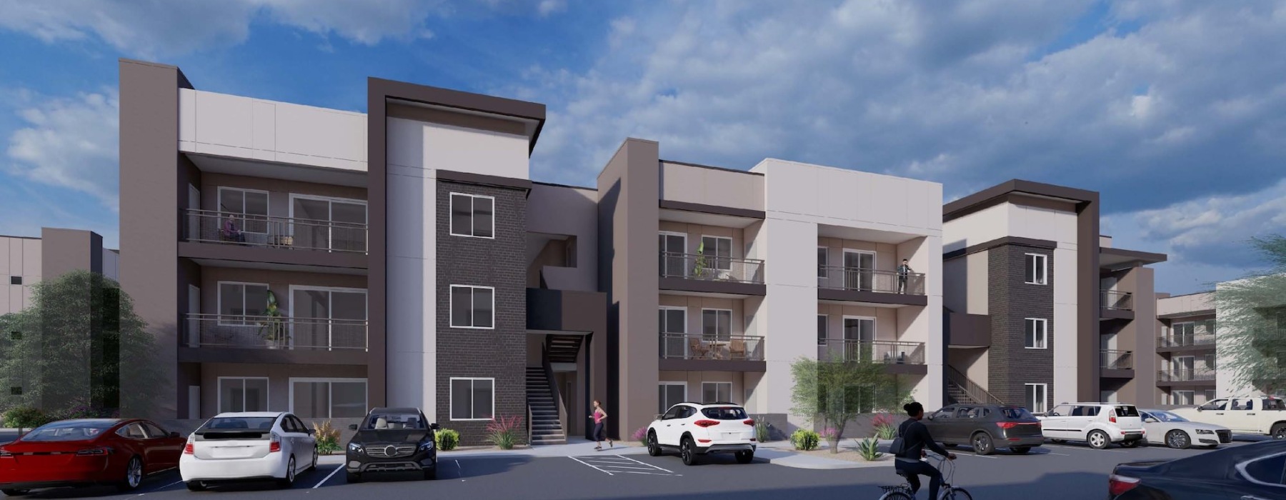 An apartment building with cars parked in front