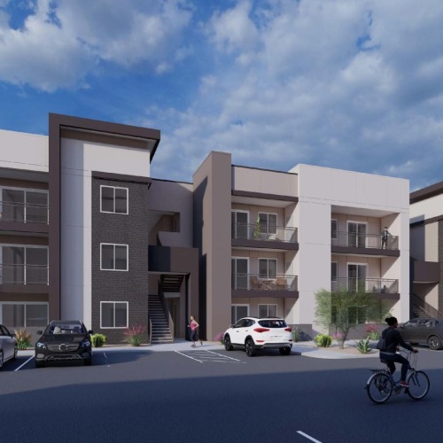 a person riding a bicycle in a parking lot next to a building