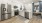 a kitchen with white cabinets a fridge a stovetop and a dishwasher